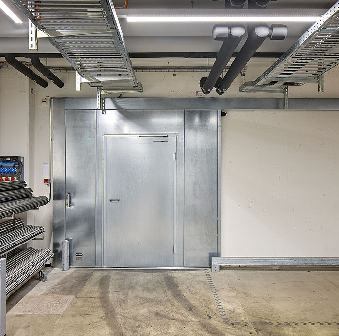 Das Brandschutzschiebetor EI30 mit integrierter Fluchttür von Wolfisberg Tor-Technik in den Innenräumen von HUG AG, Malters kommt regelmässig zum Einsatz.